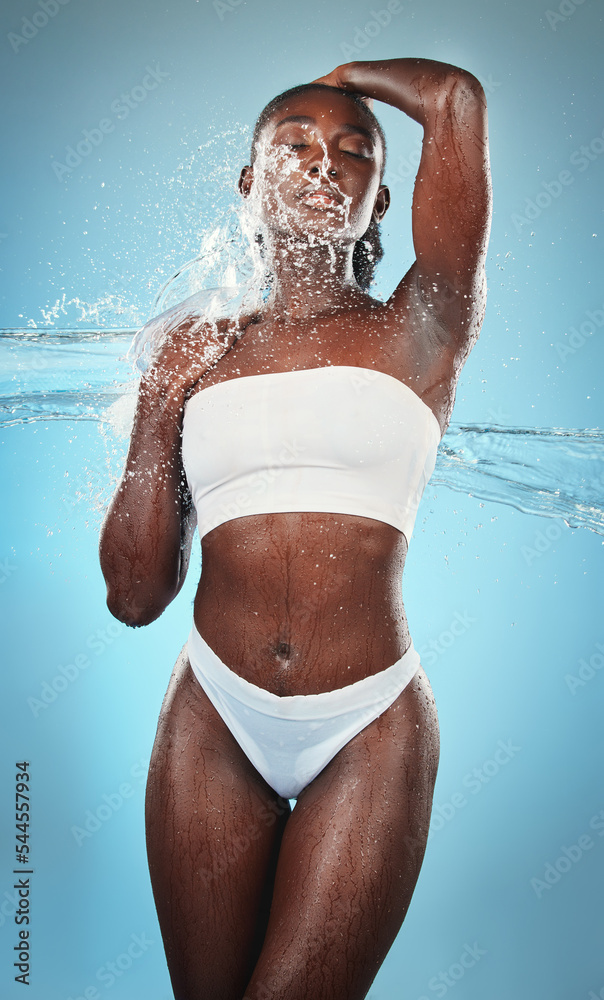 Black woman, underwear and body with water splash on blue background in  studio for skincare wellness, luxury healthcare or grooming. Beauty model,  wet liquid or hydration spray for hygiene cleaning Stock Photo