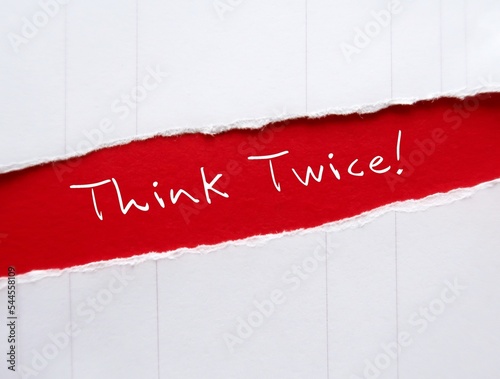 Torn red paper with handwritten messageTHINK TWICE!, means to think again or rethink before making decision,   rethinking can lead to excellence at work and wisdom in life
