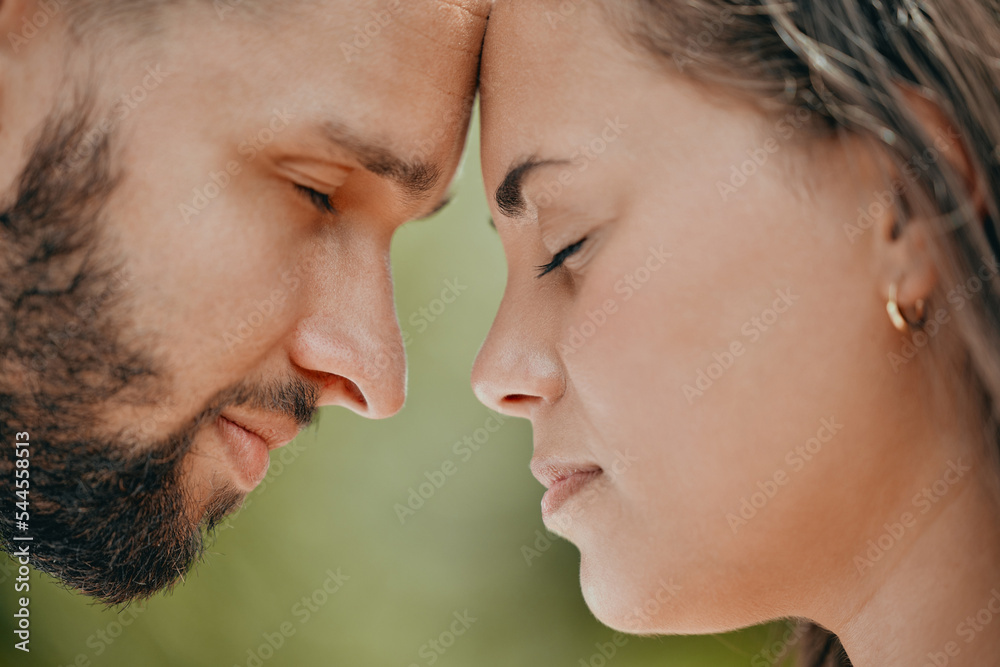 Couple, forehead and love for care, relationship or support in romance or quality bonding time together in the outdoors. Closeup of man and woman relaxing heads embracing healthy partnership outside Couple, forehead and love for care, relationship or support in romance or quality bonding time together in the outdoors. Closeup of man and woman relaxing heads embracing healthy partnership outside