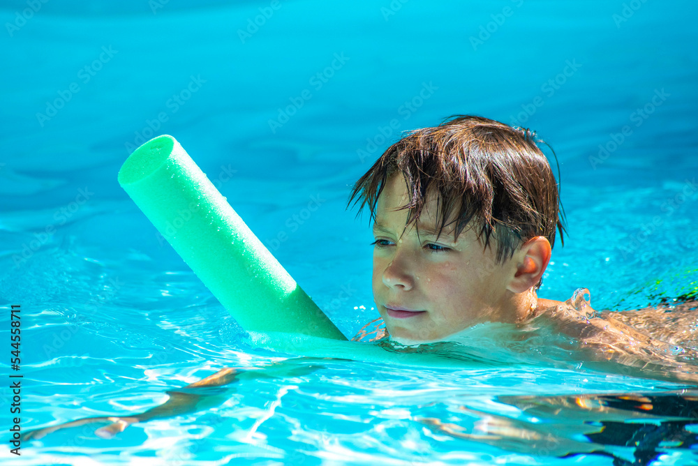 enfant avec une frite dans une piscine, apprentissage natation - obrazy, fototapety, plakaty 