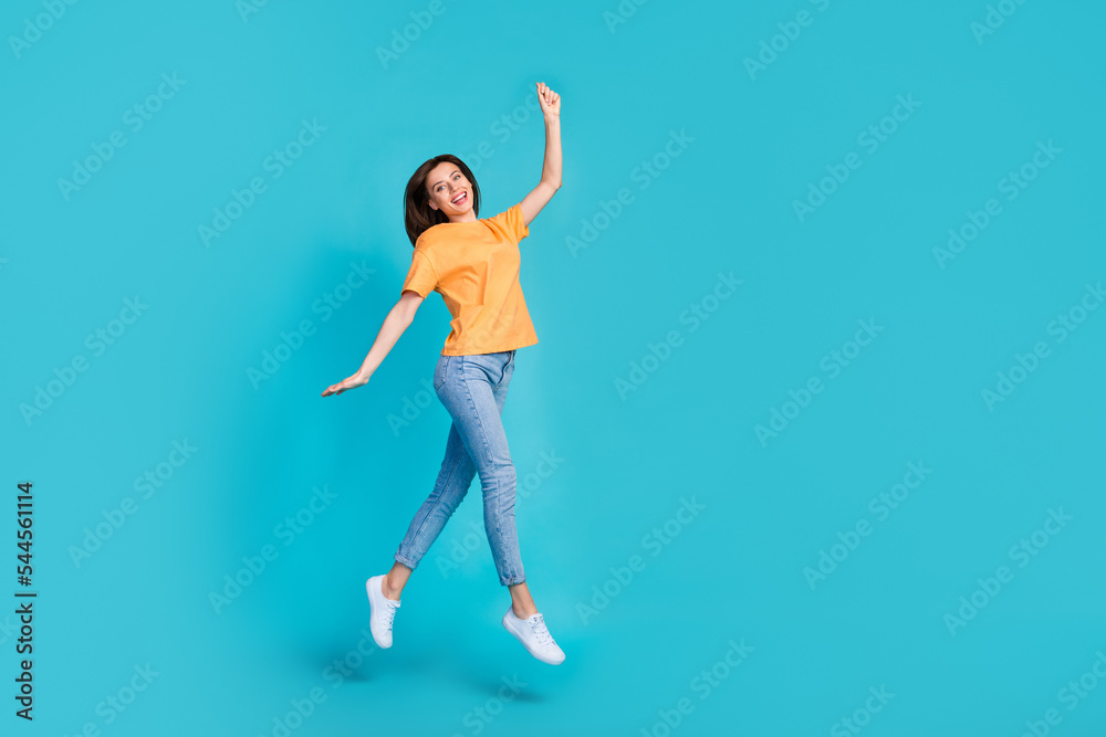 Full length photo of overjoyed lady dressed trendy orange clothes arm hold empty space black friday sale isolated on blue color background