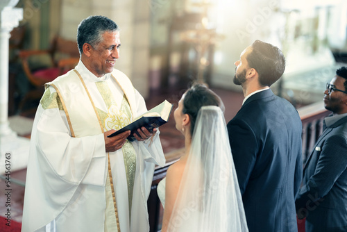 Print op canvas Wedding, couple and priest with a bible in church praying to God with a Christian pastor reading the holy book