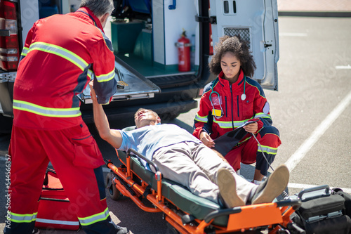 Paramedical workers providing emergency medical care to an accident victim