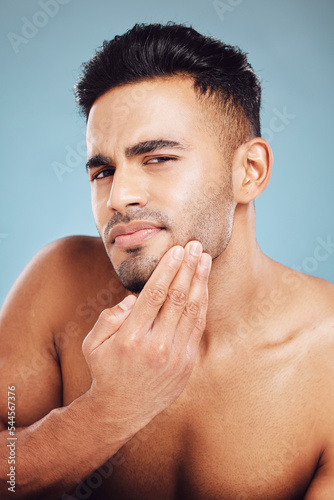 Photography Skincare, portrait and man in blue studio thinking of facial hair wellness, health and cosmetics beauty glow