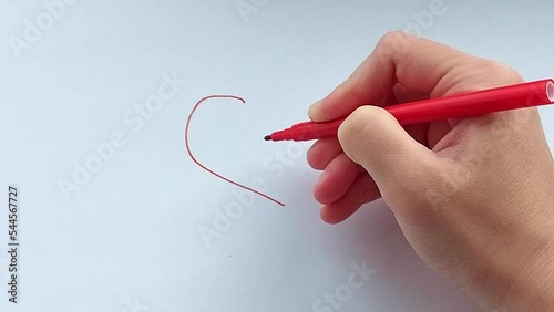 heart hand draws with a felt-tip pen on a white sheet of paper. concept of love. card for Valentines Day.