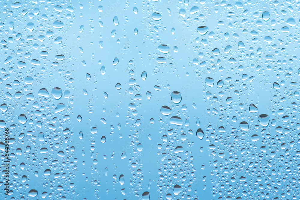 Water drops on glass against blue sky Water drops on glass against blue sky