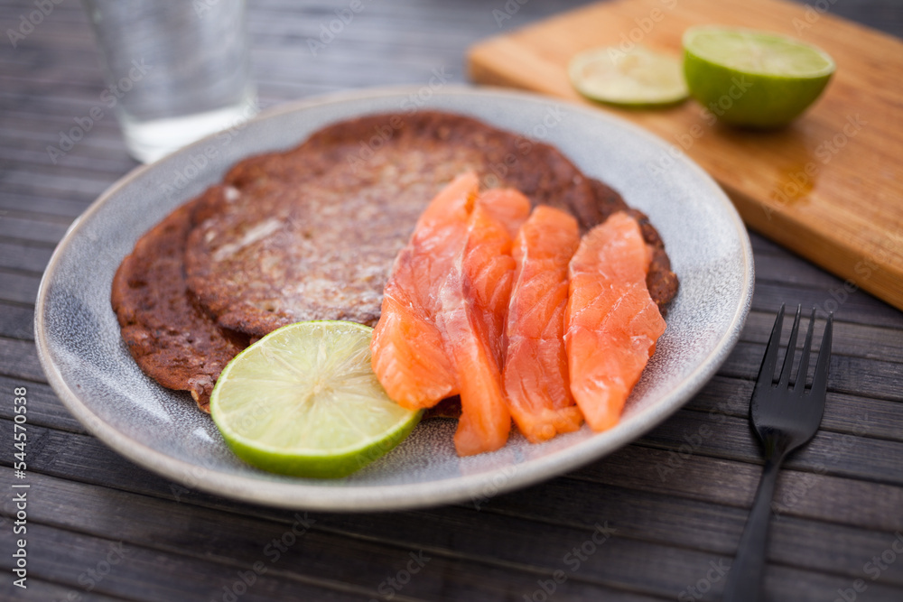 salted salmon fillet with rye pancakes and lime