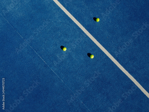 aerial view of balls on a blue paddle tennis court © Vic