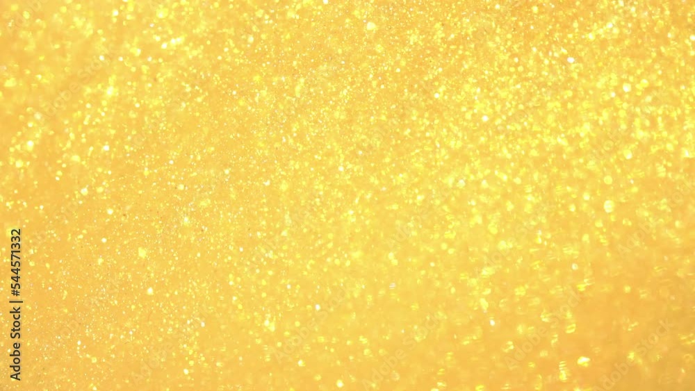 A movement of gold dust particles. A moving, flowing, stream of Golden particles in sinuous, wavy lines. Chaotic movement of moving shiny glitters . Gold flying particles abstract background. A movement of gold dust particles. A moving, flowing, stream of Golden particles in sinuous, wavy lines. Chaotic movement of moving shiny glitters . Gold flying particles abstract background.