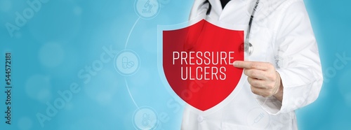 Pressure ulcers (bedsores). Doctor holding red shield protection symbol surrounded by icons in a circle. Medical word photo
