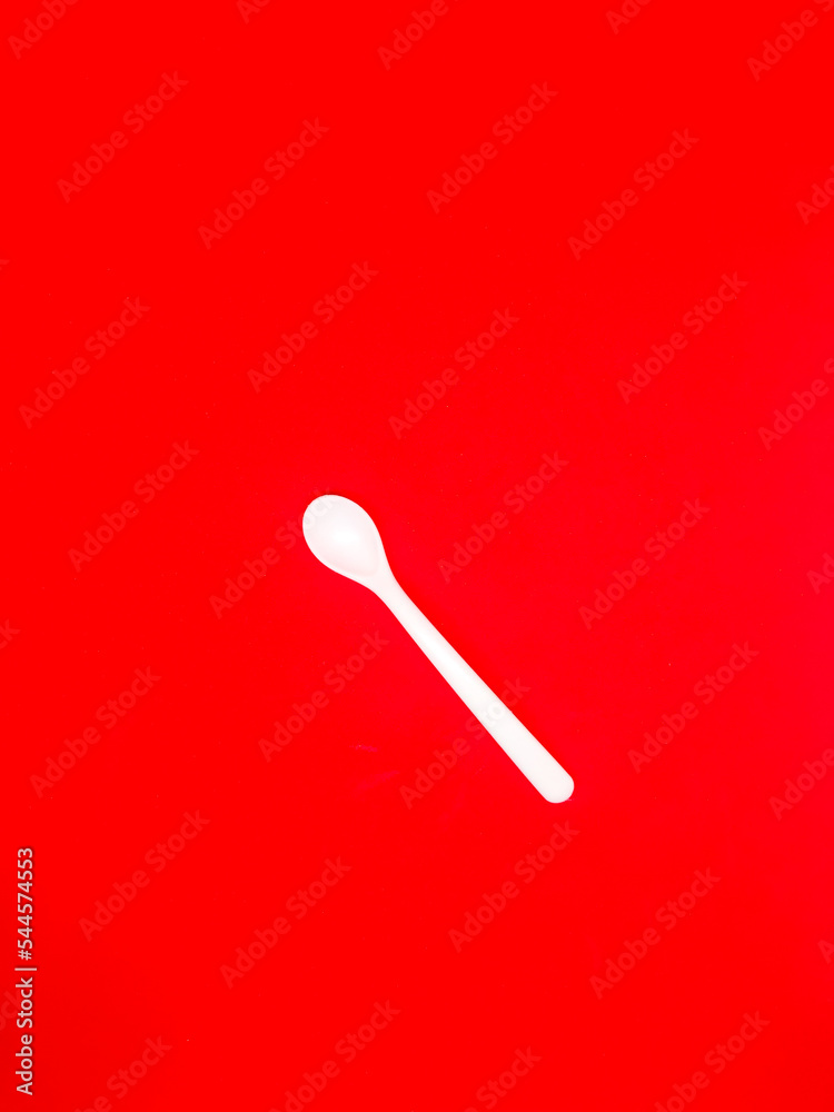 white centong and white spoon Red Background