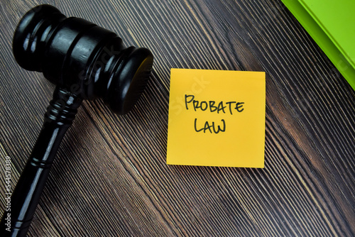 Concept of Probate Law write on sticky notes with gavel isolated on Wooden Table.