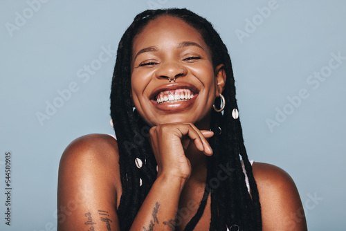 Bild auf Leinwand Happy woman with face piercings smiling at the camera