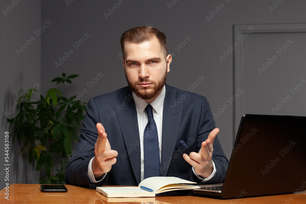 Confident successful businessman in suit works in his office. Multi-tasking concept Confident successful businessman in suit works in his office. Multi-tasking concept