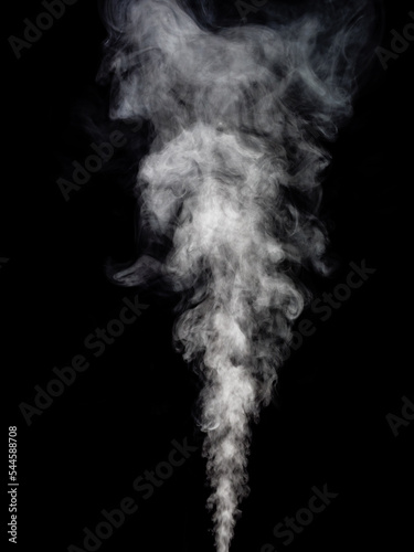 Spectacular white smoke rises in a thick stream against a black