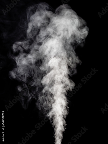 A thick stream of white smoke streams and rises up in lush tubers against a black