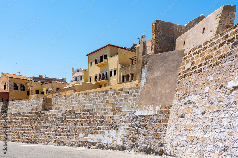 Quay wall and above it the colored houses next to the Firka Venetian Fortress in the Old Venetian Port of Chania, Crete, Greece