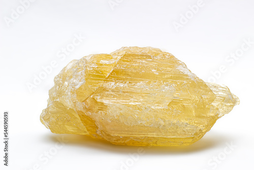 Raw uncut real honey yellow calcite crystal, calcium carbonate mineral with visible structure macro isolated on a white background surface 