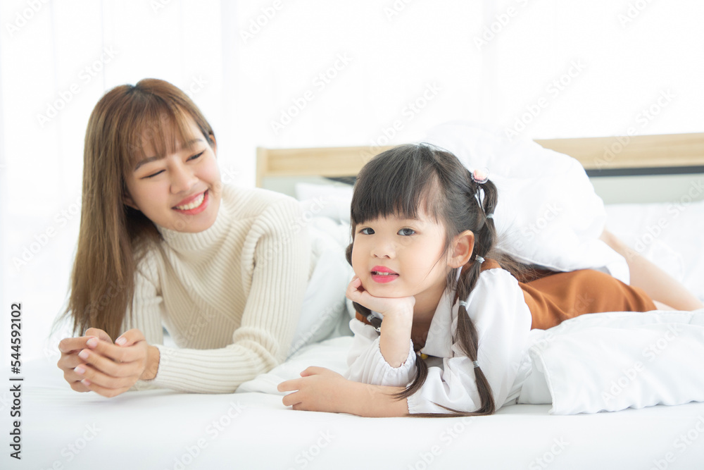 Happy loving family. Asian mother and her daughter child girl playing in bedroom. Happy loving family. Asian mother and her daughter child girl playing in bedroom.