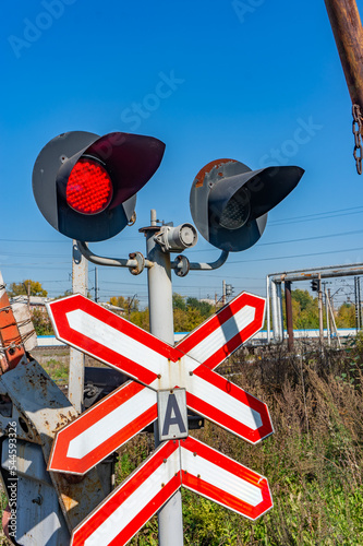 Railway traffic lights with a red signal. Railway and road crossing. Forbidding Motion signal.