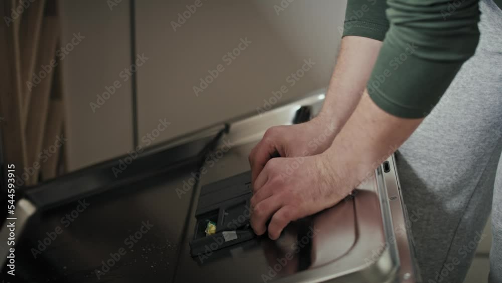 Adult man with down syndrome turning on dishwasher at home. Shot with RED helium camera in 8K. Adult man with down syndrome turning on dishwasher at home. Shot with RED helium camera in 8K.
