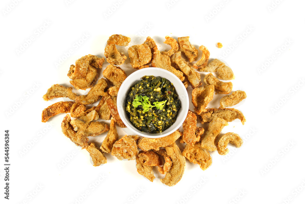 Homemade crispy pork rind with green chili paste on white background