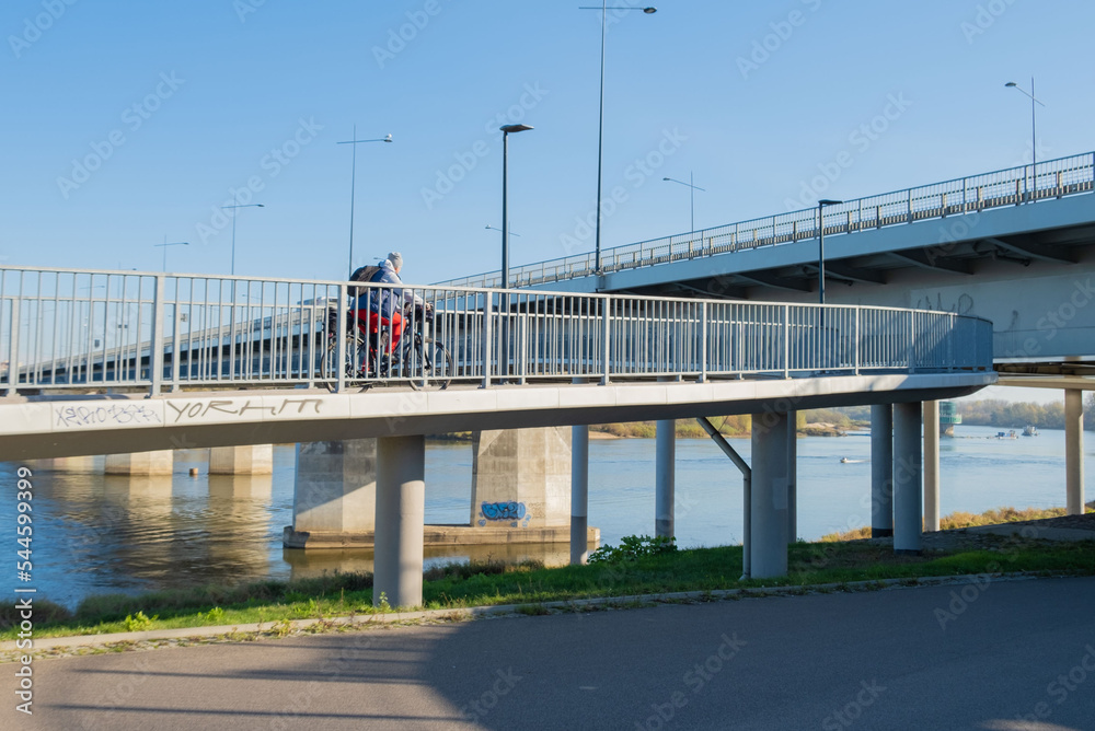 A cyclist rides to the bridge. The bike goes to the bridge.