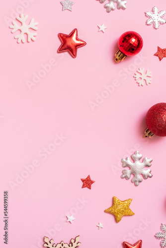 Christmas decorations flat lay on a pink background. Top view xmas or New Year background with copy space
