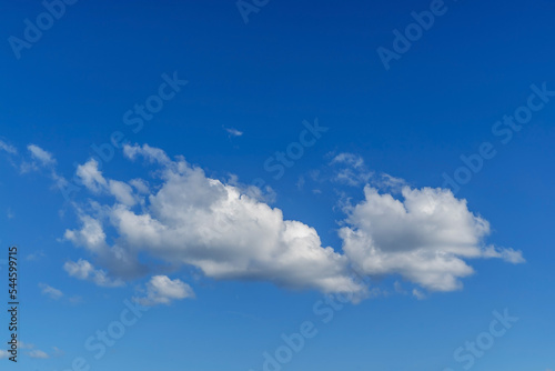 White clouds in a blue sky of different shapes.