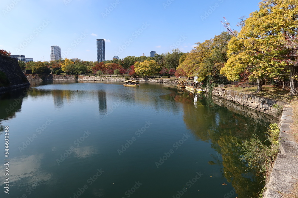A Japanese castle : the moat and stone wall of Osaka-jyo Castle and an excursion boat in Osaka City 日本のお城：大阪市の大阪城の堀と石垣と観光ボート