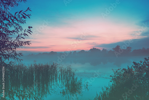 Fototapeta Naklejka Na Ścianę i Meble -  Magic serene sunrise over the lake. Misty early morning, rural landscape, wilderness