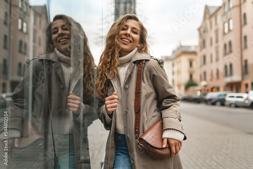 Autumn portrait of young fashionable woman wearing trendy coat in the street