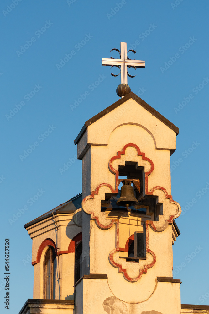 Church bell tower isolated against blue sky, Orthodox memorial church