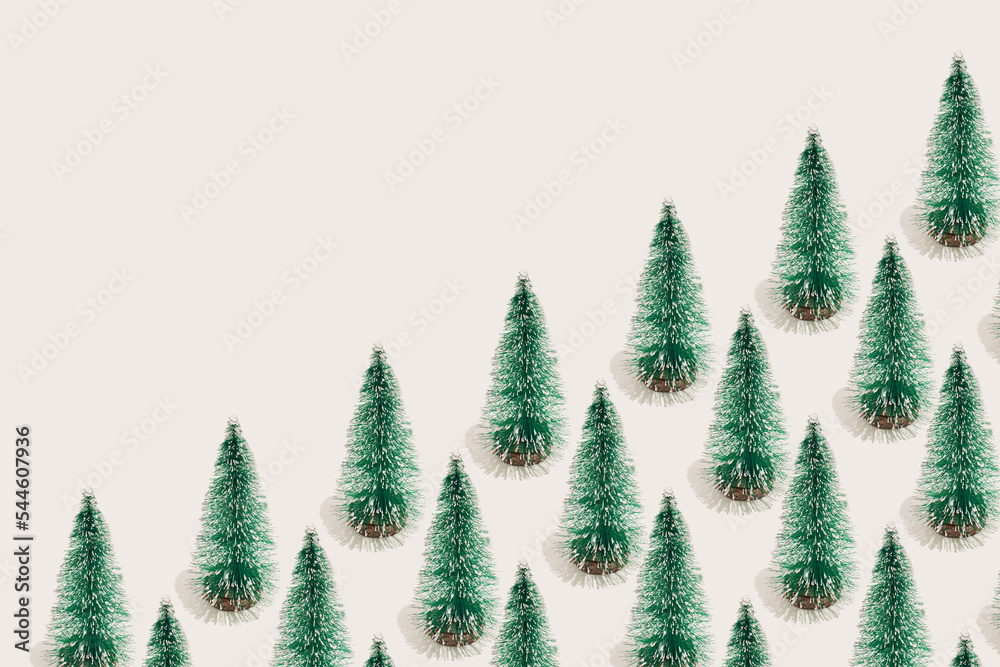 Minimal New Year and winter holidays composition. Seamless pattern of green Christmas trees on white background.