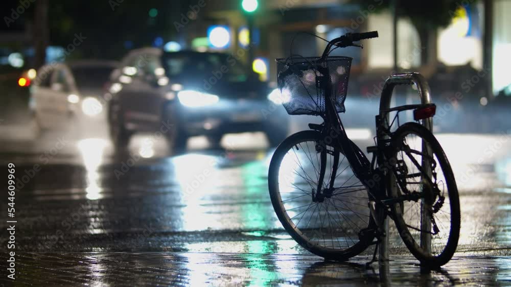 Bicycle parked on the street, evening, rain Bicycle parked on the street, evening, rain