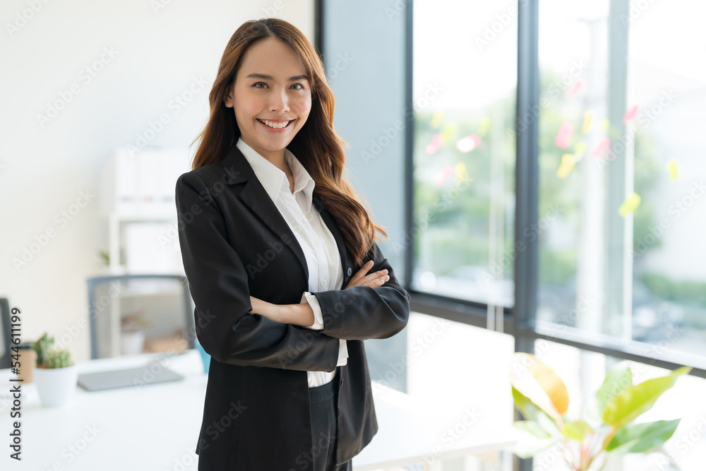Young businesswoman standing with crossed arms smiling. Young businesswoman standing with crossed arms smiling.