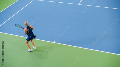 Female Tennis Player Just Served by Hitting Ball with a Racquet During Championship Match. Professional Woman Athlete Successfully Strikes. World Sports Tournament. High Angle Wide Shot.