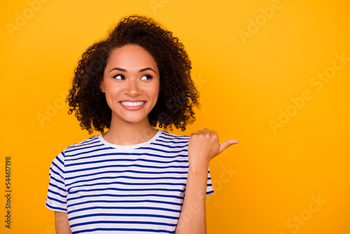 Photo of charming dreamy lady wear white t-shirt looking showing thumb empty space isolated yellow color background