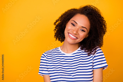 Photo of funny dreamy lady wear white t-shirt smiling empty space isolated yellow color background