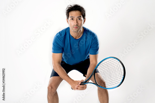 Male tennis player playing tennis with striving for victory gesture.