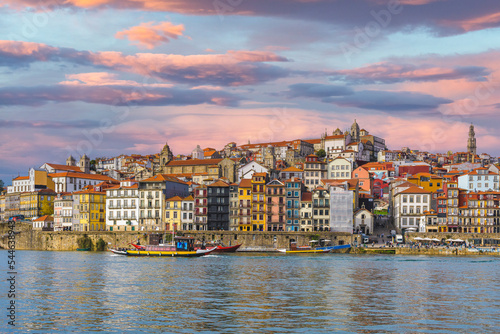 Panoramic view of Old Porto under the sunset sky. Oporto city and Ribeira over Douro river from Vila Nova de Gaia, Portugal