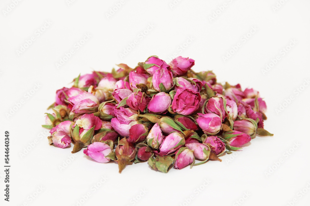 tea made from dried buds and petals of a pink rose on a white background tea made from dried buds and petals of a pink rose on a white background