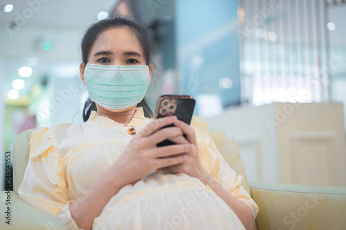 health care Pregnant wearing mask in public area protect coronavirus, Pregnant using smartphone