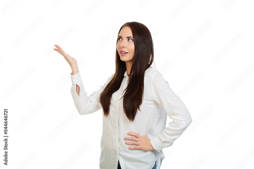 Young, beautiful girl on a white background points his hands at the place for promo, offers or advertising. Young, beautiful girl on a white background points his hands at the place for promo, offers or advertising.