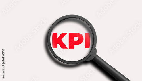 KPI word lettering typography with magnifying glass zooming the word KPI on white background. 3D illustration.