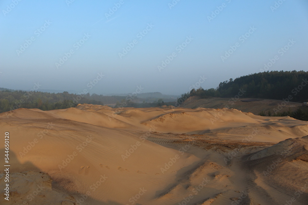 landscape with sand and a blue sky in the back
