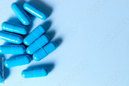Blue capsules on blue background