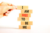 I am free to be me symbol. Concept words I am free to be me on wooden blocks on a beautiful white table white background. Businessman hand. Business i am free to be me concept.