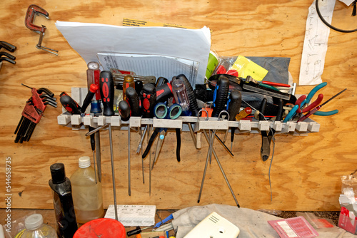 Rack of tools in a sewing machine repairman's shop in his home. St Paul Minnesota MN USA