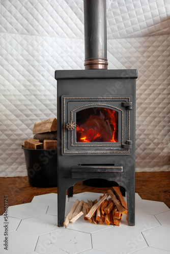 Obraz na płótnie A vintage stove is heated with wood, heats a country house w salonie